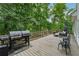 Entertaining deck with grill and seating, ideal for outdoor dining and gatherings with wooded backdrop at 34 Johnston Nw Row, Cartersville, GA 30121