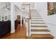 Bright, open foyer features hardwood floors, staircase with white risers, and an open view to the living room at 34 Johnston Nw Row, Cartersville, GA 30121