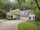 Exterior of a charming home with gabled windows and a two-car garage, surrounded by trees at 34 Johnston Nw Row, Cartersville, GA 30121