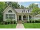 Beautiful home featuring a welcoming front porch, well-kept lawn, stone accents, and decorative shutters at 34 Johnston Nw Row, Cartersville, GA 30121