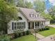 Inviting home with a covered front porch, stone accents, lush lawn, and a three car garage at 34 Johnston Nw Row, Cartersville, GA 30121
