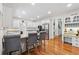 Bright kitchen boasts white cabinetry, granite countertops, stainless steel appliances, and a convenient breakfast bar at 34 Johnston Nw Row, Cartersville, GA 30121