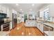 Open kitchen showcasing granite countertops, stainless appliances, white cabinets, and a view into the dining area at 34 Johnston Nw Row, Cartersville, GA 30121
