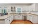 Well-lit kitchen features granite counters, stainless steel dishwasher, white cabinets, and a garden window at 34 Johnston Nw Row, Cartersville, GA 30121