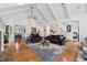 Open concept living room with hardwood floors, coffered ceilings, and a seamless flow to the dining area at 34 Johnston Nw Row, Cartersville, GA 30121