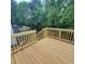 Wooden back deck overlooking a green backyard with trees and a fence at 3045 Binghampton Ln, Lawrenceville, GA 30044