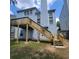 Exterior of home showing raised back deck with stairs descending to the backyard at 3045 Binghampton Ln, Lawrenceville, GA 30044