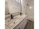 Bathroom with dual sinks, granite countertops, modern fixtures and shower-tub combo at 3045 Binghampton Ln, Lawrenceville, GA 30044