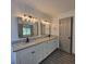 Elegant bathroom with dual sinks, granite countertops, and stylish vanity mirrors at 3045 Binghampton Ln, Lawrenceville, GA 30044