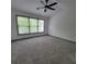 Spacious bedroom with large windows, a ceiling fan, and neutral gray carpet at 3045 Binghampton Ln, Lawrenceville, GA 30044