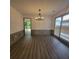 Elegant dining room with wood floors, wainscoting, modern lighting, and access to deck at 3045 Binghampton Ln, Lawrenceville, GA 30044