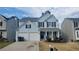 Charming light-blue two-story home with a two-car garage and manicured front yard at 3045 Binghampton Ln, Lawrenceville, GA 30044