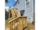 View of back exterior showing stairs to deck and light blue siding at 3045 Binghampton Ln, Lawrenceville, GA 30044