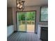 Modern kitchen with new light fixture, stainless steel appliances, granite countertops and sliding glass door to wood deck at 3045 Binghampton Ln, Lawrenceville, GA 30044