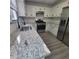 Close up of a kitchen with white cabinets, stainless steel appliances, and granite countertops, great for Gathering meals at 3045 Binghampton Ln, Lawrenceville, GA 30044