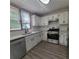 Bright kitchen featuring white cabinets, stainless steel appliances, granite countertops, and stylish backsplash, perfect for modern living at 3045 Binghampton Ln, Lawrenceville, GA 30044