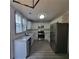 Bright kitchen featuring white cabinets, stainless steel appliances, granite countertops, and stylish backsplash, perfect for modern living at 3045 Binghampton Ln, Lawrenceville, GA 30044