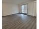 Neutral room featuring wood flooring, neutral paint, and large window at 3045 Binghampton Ln, Lawrenceville, GA 30044