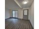 Bright living room featuring wood flooring, neutral paint, and exterior access at 3045 Binghampton Ln, Lawrenceville, GA 30044