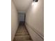 Carpeted stairwell with white walls and railing, leading to the next level at 3045 Binghampton Ln, Lawrenceville, GA 30044