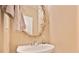 Bathroom features include a pedestal sink, decorative mirror, and neutral wall color at 1979 Spivey Village Dr, Jonesboro, GA 30236