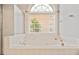 Relaxing bathtub with window view, perfect for unwinding after a long day at 1979 Spivey Village Dr, Jonesboro, GA 30236