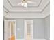 Spacious bedroom featuring gray walls and a decorative tray ceiling with a ceiling fan at 1979 Spivey Village Dr, Jonesboro, GA 30236