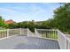 Back deck with white banister, surrounded by green foliage at 1979 Spivey Village Dr, Jonesboro, GA 30236