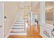 Elegant foyer with hardwood floors, staircase, and chandelier, creating a grand entrance at 1979 Spivey Village Dr, Jonesboro, GA 30236