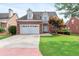 Charming brick two-story home featuring a well-manicured lawn and an attached two-car garage at 1979 Spivey Village Dr, Jonesboro, GA 30236
