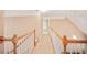 Upstairs hallway with carpeted floor and white banister at 1979 Spivey Village Dr, Jonesboro, GA 30236