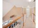 Upstairs hallway with carpeted floor and white banister at 1979 Spivey Village Dr, Jonesboro, GA 30236