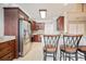 Kitchen featuring stainless steel appliances, dark wood cabinets, a breakfast bar, and tile flooring at 1979 Spivey Village Dr, Jonesboro, GA 30236