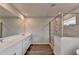 Bathroom features a large vanity with dual sinks and walk-in shower with tiled surround at 3968 Annsbury Court, Lilburn, GA 30047