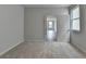 Sunlit bedroom showcasing plush carpet, a light fixture, and neutral walls at 3968 Annsbury Court, Lilburn, GA 30047