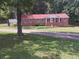 Charming brick home features a red roof, a columned front porch and a beautifully landscaped yard at 6005 Hendrix Rd, Cumming, GA 30040