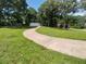 Exterior view of a charming home with a long driveway and manicured lawn at 6005 Hendrix Rd, Cumming, GA 30040