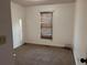 Bedroom featuring neutral carpet, blinds, and a window allowing natural light at 7472 Woods Ct, Lithonia, GA 30058