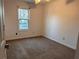 Bedroom featuring neutral carpet, blinds, and a window allowing natural light at 7472 Woods Ct, Lithonia, GA 30058