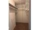 A walk-in closet featuring metal shelving and neutral carpet at 7472 Woods Ct, Lithonia, GA 30058