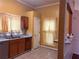 Kitchen featuring wooden cabinets, silver dishwasher, tile flooring, and window at 7472 Woods Ct, Lithonia, GA 30058