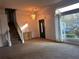 Spacious living room featuring a chandelier and staircase at 7472 Woods Ct, Lithonia, GA 30058