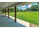 Relaxing covered back porch with views of the expansive backyard and mature trees at 858 Pates Creek Rd, Stockbridge, GA 30281
