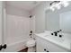 Bathroom with a combination shower and tub, accompanied by a white vanity and dark fixtures at 858 Pates Creek Rd, Stockbridge, GA 30281