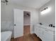 Bathroom featuring double sinks, marble countertops, and a soaking tub at 858 Pates Creek Rd, Stockbridge, GA 30281