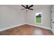 Bedroom boasting hardwood floors, a ceiling fan, and a window showcasing the outdoor view at 858 Pates Creek Rd, Stockbridge, GA 30281