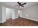 Bright bedroom features hardwood floors, ceiling fan, and closet with double doors at 858 Pates Creek Rd, Stockbridge, GA 30281
