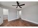 This bedroom includes hardwood floors, a ceiling fan, and a closet with shelving at 858 Pates Creek Rd, Stockbridge, GA 30281