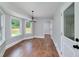 Bright dining room featuring hardwood floors, a modern chandelier, and large windows at 858 Pates Creek Rd, Stockbridge, GA 30281