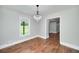 Bright dining room featuring hardwood floors and a decorative chandelier with window views at 858 Pates Creek Rd, Stockbridge, GA 30281
